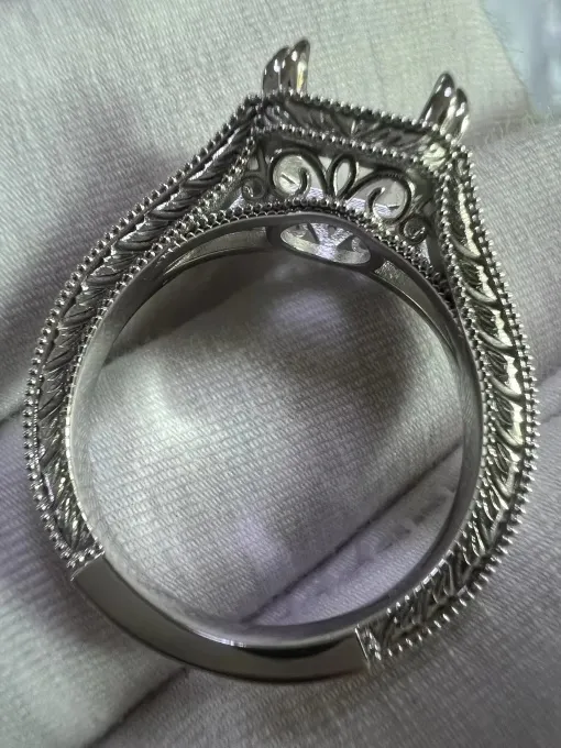 Close-up of an intricate Art Deco sterling silver ring setting with milgrain detail